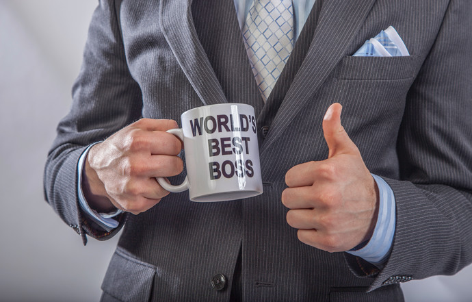 Holding "World's Best Boss" mug